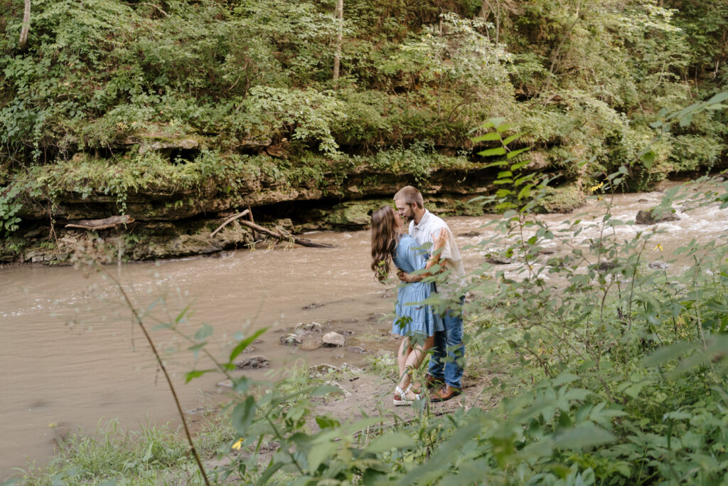 couple almost kissing by the river at white water park Minnesota