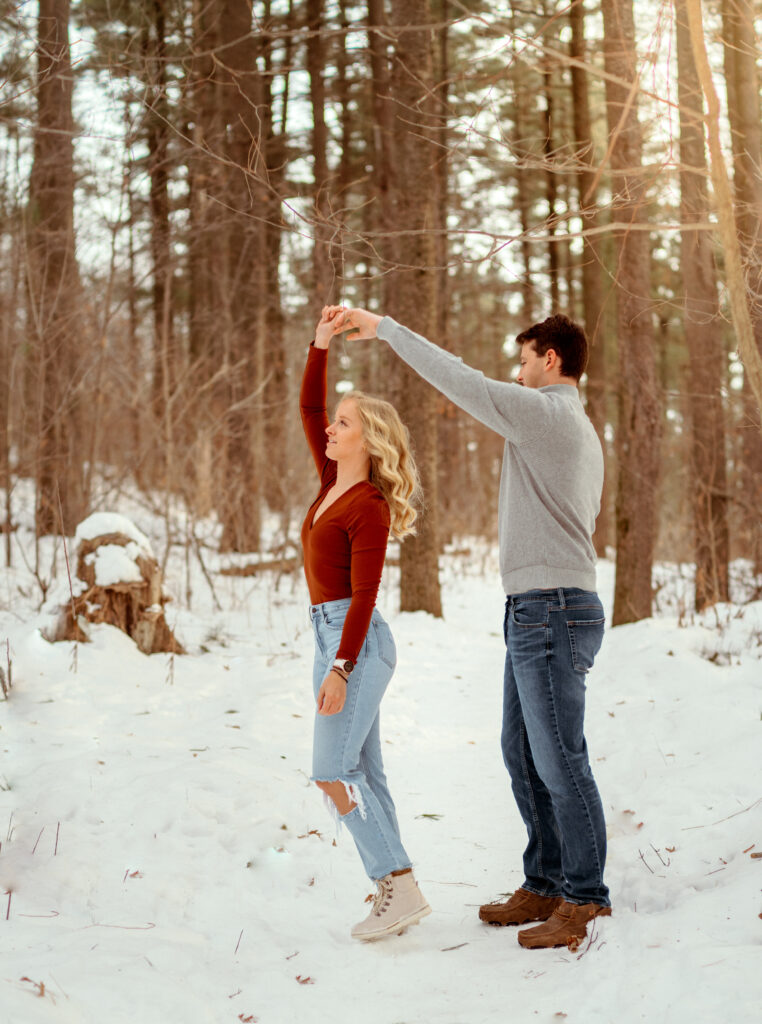 guy spinning girlfriend in a wooded forest in rochester mm.